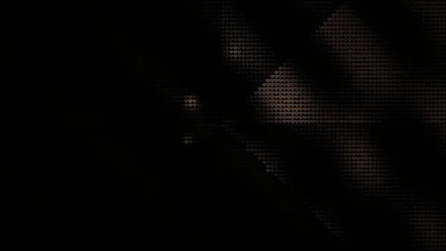 Close up of hands working on an art project in a dimly lit studio