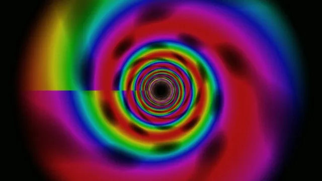 Colorful light swirl in a dark space during a digital art display