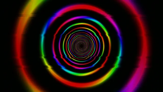 Colorful spirals move in a circular pattern with a dark background
