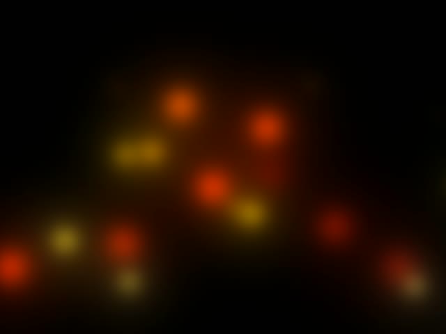 SCHRITT 1: Das Bild zeigt verschwommene, leuchtende Punkte in Orange-, Rot- und Gelbfarbtönen auf